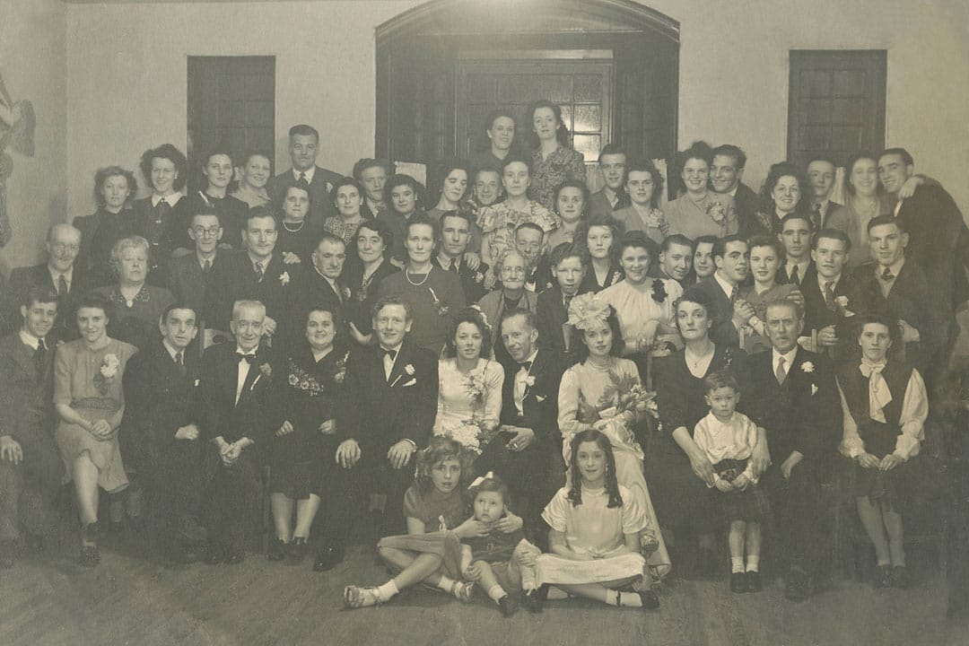 Tina McKenzie front right next to her parents with John Jr on their knee at sister Melinda's wedding 1949